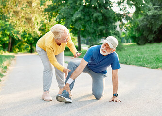 Active senior people jogging together injury problem  in the park