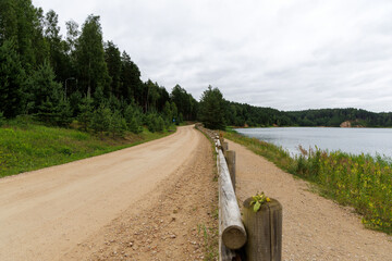 Rural Road Alongside Forest Lake