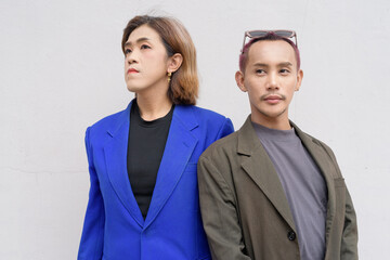 Gender inclusive business team couple against white background