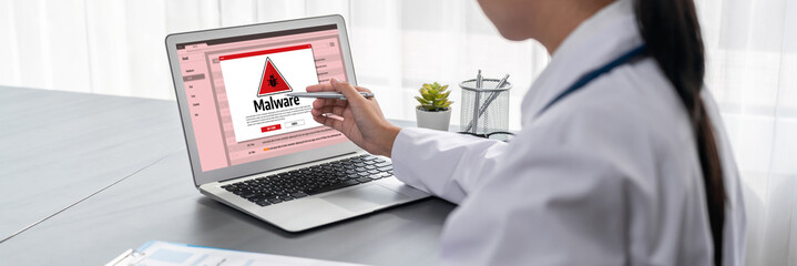 Cyber attacking concept. Malware alert showing on computer screen display scam and threat detection on computer system or online server to be removed brisk.