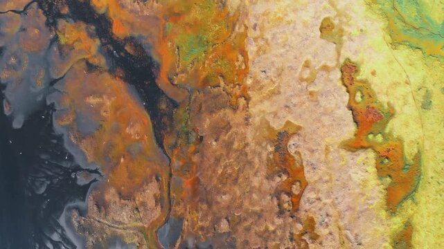 Aerial view shows a textured landscape with vibrant colors and patterns