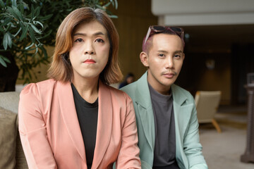 Transgender and non-binary coworkers working remotely in cafe