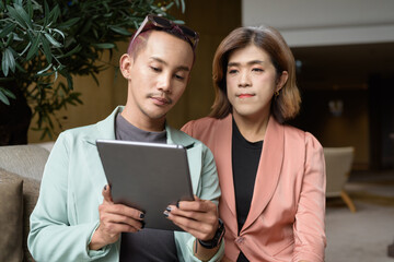 Transgender and non-binary coworkers working remotely in cafe