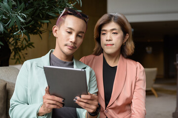 Transgender and non-binary coworkers working remotely in cafe