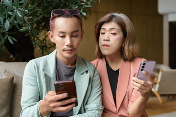 Transgender and non-binary coworkers working remotely in cafe