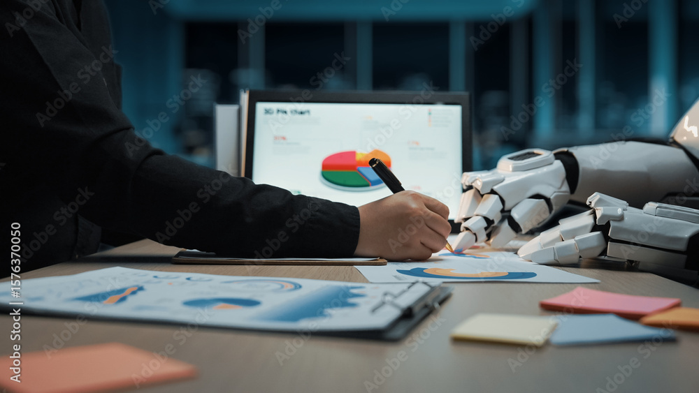 Poster a human hand collaborates with a robotic arm in a modern workspace, focusing on data analysis throug