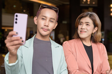 Transgender and non-binary coworkers working remotely in cafe