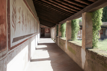 Obraz premium Sunlight illuminating corridor of domus of octavius quartio, pompeii, showing frescoes and garden