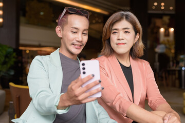 Transgender and non-binary coworkers working remotely in cafe