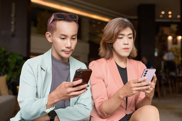 Transgender and non-binary coworkers working remotely in cafe