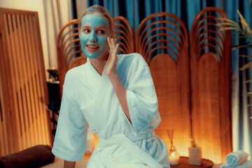 Serene ambiance of spa salon, woman customer indulges in rejuvenating with luxurious face cream...