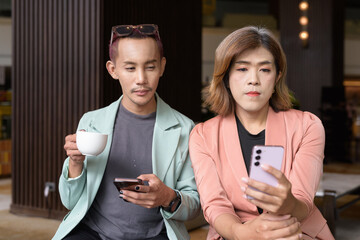 Transgender and non-binary coworkers working remotely in cafe
