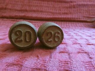 The year 2026 is formed by vintage  Bingo wooden barrels on a textured fabric. A metaphor for...