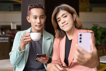 Transgender and non-binary coworkers working remotely in cafe