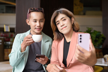 Transgender and non-binary coworkers working remotely in cafe