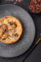 Pie or quiche, a sour tart with chicken and mushrooms, spices and herbs. Round quiche with chicken
