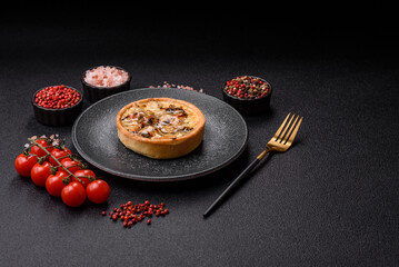Pie or quiche, a sour tart with chicken and mushrooms, spices and herbs. Round quiche with chicken