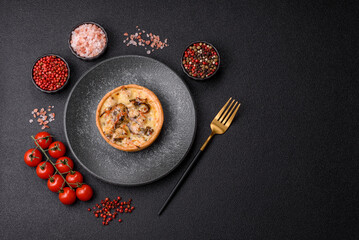 Pie or quiche, a sour tart with chicken and mushrooms, spices and herbs. Round quiche with chicken