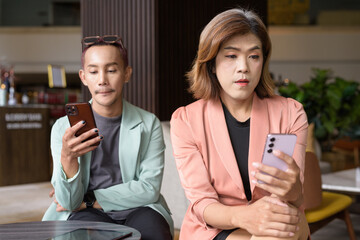 Transgender and non-binary coworkers working remotely in cafe