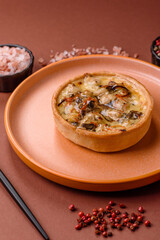 Pie or quiche, a sour tart with chicken and mushrooms, spices and herbs. Round quiche with chicken