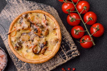 Pie or quiche, a sour tart with chicken and mushrooms, spices and herbs. Round quiche with chicken