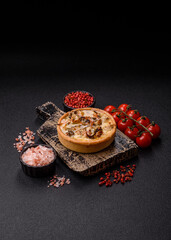 Pie or quiche, a sour tart with chicken and mushrooms, spices and herbs. Round quiche with chicken