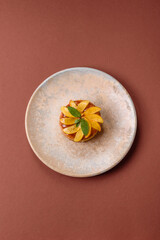 Sweet round pie or tart with apples and peach. Mini sweet tart