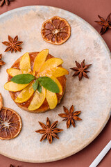 Sweet round pie or tart with apples and peach. Mini sweet tart