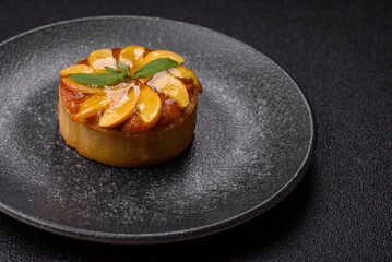 Sweet round pie or tart with apples and peach. Mini sweet tart