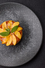 Sweet round pie or tart with apples and peach. Mini sweet tart