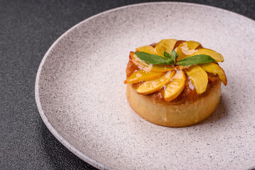 Sweet round pie or tart with apples and peach. Mini sweet tart