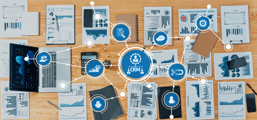 A comprehensive overview of business analytics and customer relationship management featuring graphs, charts, and digital devices laid out on a professional desk workspace. Amity