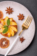 Sweet round pie or tart with apples and peach. Mini sweet tart