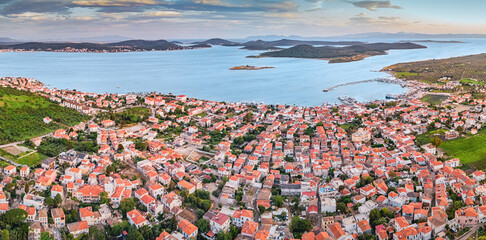Panoramic aerial view of Ayvalik town on Cunda island, at sunset illuminating the red rooftops and...