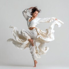 A female dancer in Latin dance pose with motion in clothing on white background