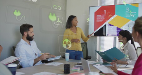 Pointing woman presenting infographic slides on monitor in conference room, binders and tablet