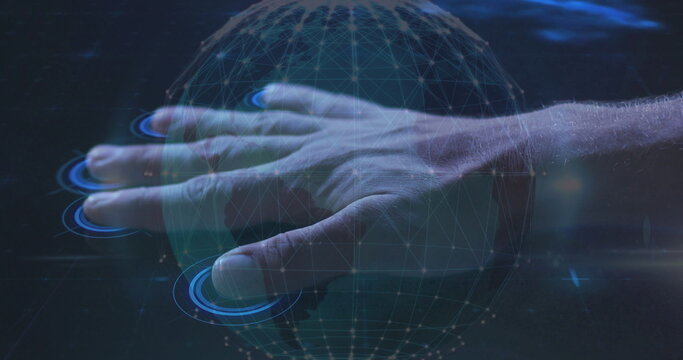 Extending male hand touching digital globe wireframe in virtual space, with blue touch indicators