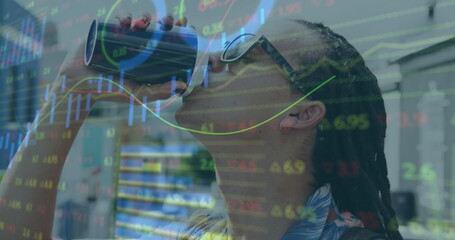 Drinking sunglassed man sipping from tumbler in office, with stock graphs overlay, copy space
