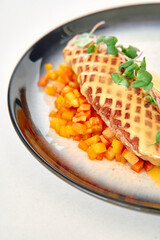 Gourmet dish with grilled turkey breast and sautéed vegetables on elegant plate with microgreens garnish