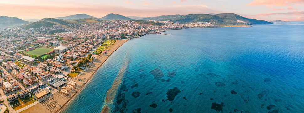 Stunning aerial view of Dikili coastline, bathed in the warm glow of sunset, showcasing the beautiful turquoise waters of the Aegean Sea