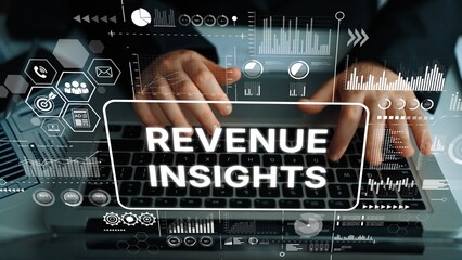 Business Professional Analyzing Revenue Insights Data Through Computer Keyboard with Graphs and...