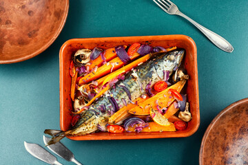 Mackerel with roasted vegetables on a tray.