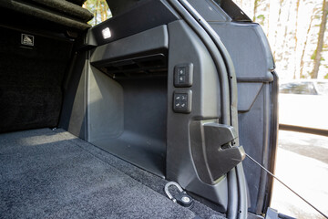 Fototapeta premium This is an interior view of a modern SUV focusing on the cargo area, which features a welldesigned storage compartment along with various controls that enhance functionality and organization