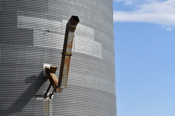 Grain chute on side of large silo.