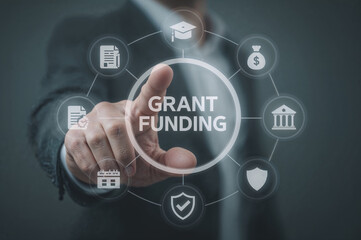 Businessman touching screen with grant funding options and icons for education and finance