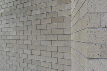 Brick wall. Two distinct angles in wall. Light tan color.