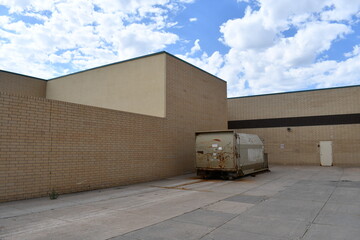 Liminal space. Dumpster behind shopping mall.