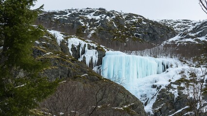 Frozen waterfall in snowy mountain landscape — winter ice and icicles
