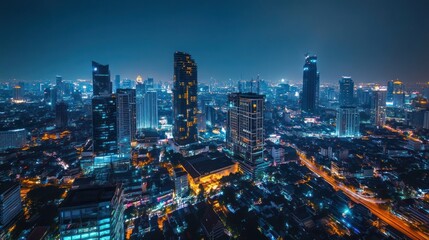 Fototapeta premium Night cityscape, aerial view, urban sprawl, illuminated buildings, city lights, traffic, metropolis, background blur, advertising, travel