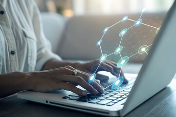 Person typing on a laptop with a glowing digital network overlay